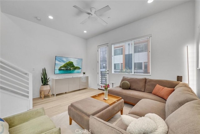 living area with wood finished floors, baseboards, a ceiling fan, recessed lighting, and stairs