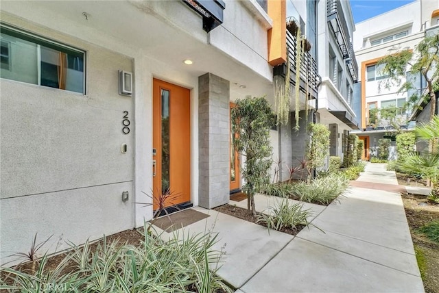 property entrance with stucco siding