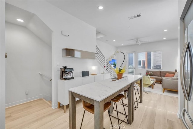 kitchen featuring visible vents, light wood-type flooring, recessed lighting, stainless steel fridge, and baseboards