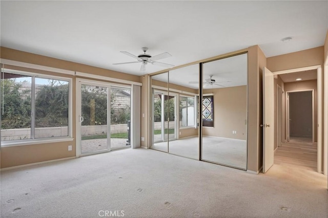 unfurnished sunroom featuring a ceiling fan