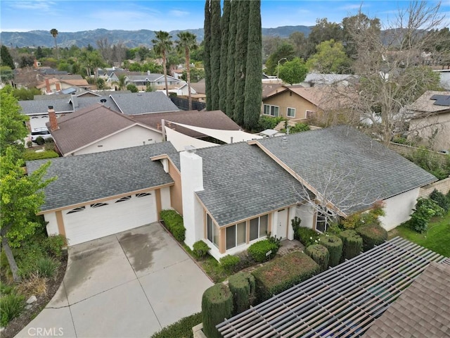 birds eye view of property with a mountain view and a residential view