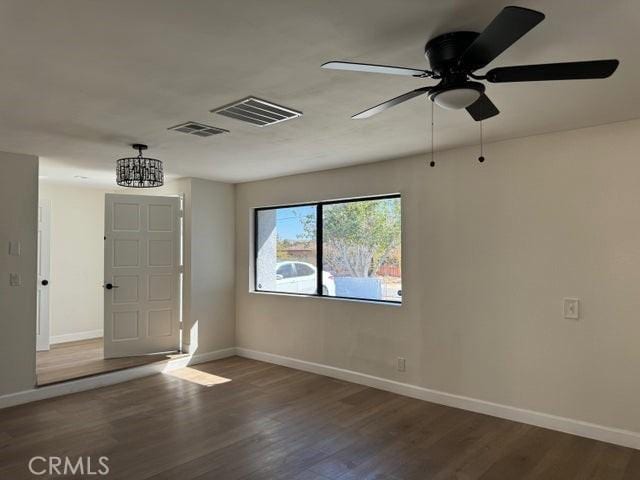 foyer entrance with visible vents, baseboards, and wood finished floors