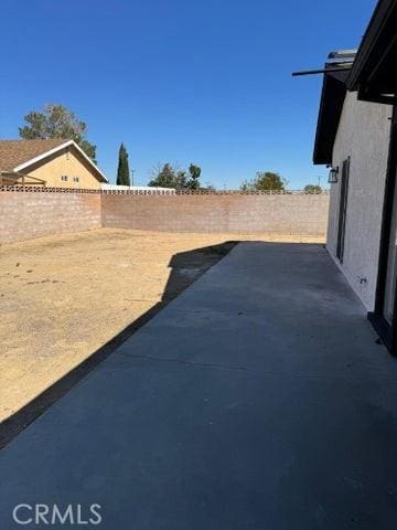 view of yard featuring a patio area and a fenced backyard