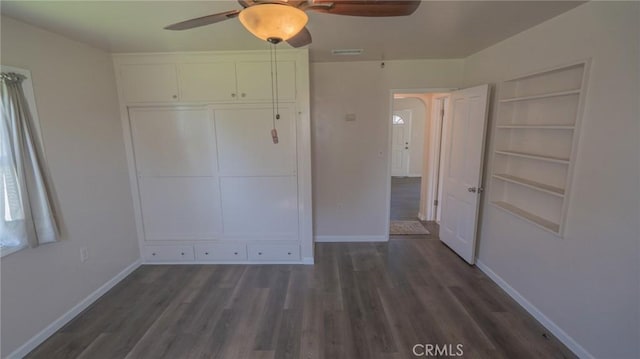 unfurnished bedroom with visible vents, baseboards, a closet, and wood finished floors