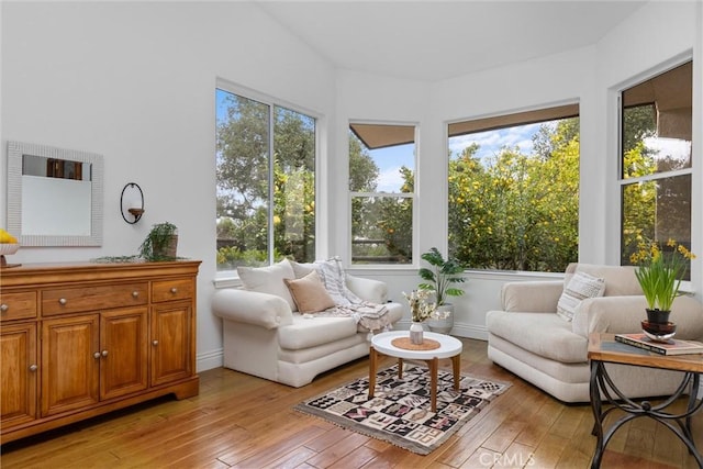 sunroom with hardwood / wood-style flooring, baseboards, and a deck