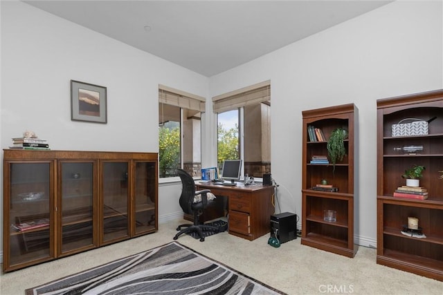 carpeted office space featuring baseboards