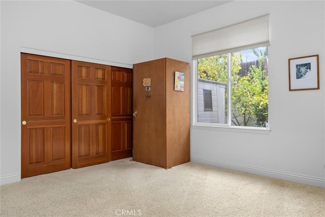 unfurnished bedroom with carpet flooring and baseboards