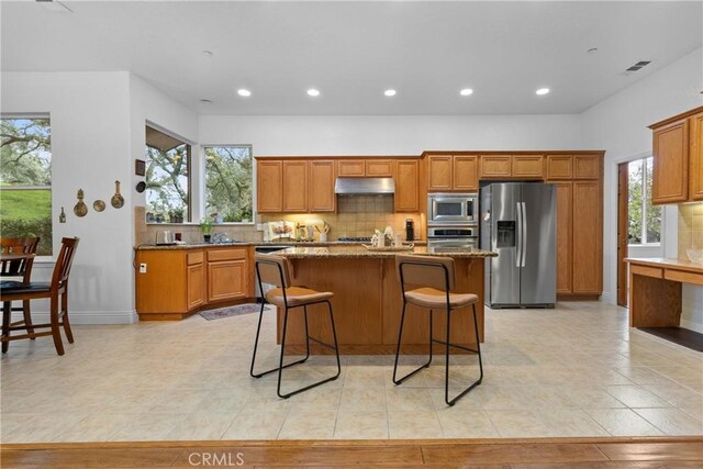 kitchen featuring stainless steel appliances, visible vents, recessed lighting, and under cabinet range hood