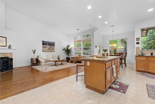 kitchen with recessed lighting, visible vents, open floor plan, and a healthy amount of sunlight