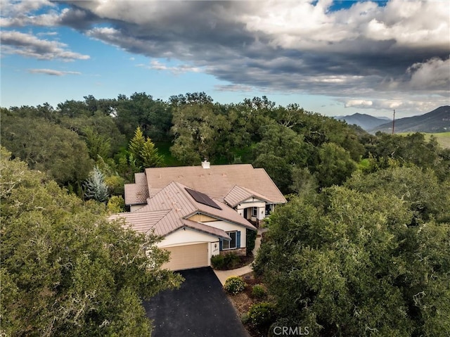 drone / aerial view with a forest view and a mountain view