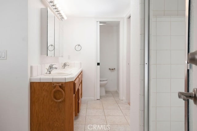 full bathroom with tile patterned floors, toilet, and vanity