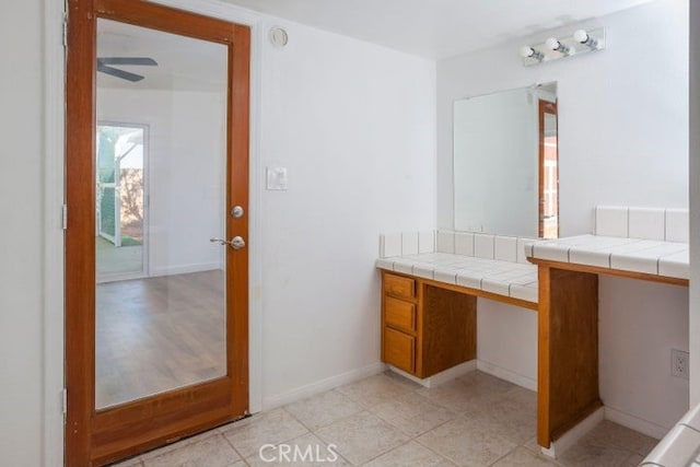 bathroom with tile patterned floors and baseboards