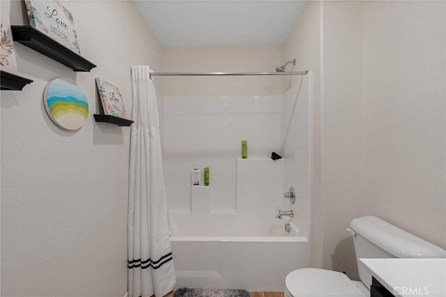 full bathroom with vanity, toilet, and shower / bath combo with shower curtain