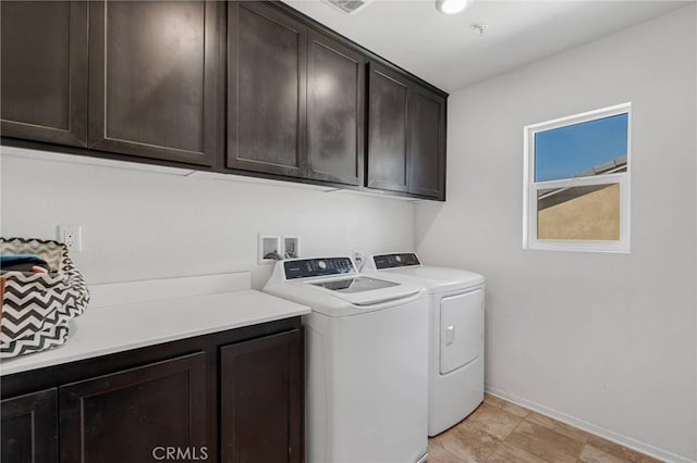 washroom with washer and clothes dryer, cabinet space, and baseboards