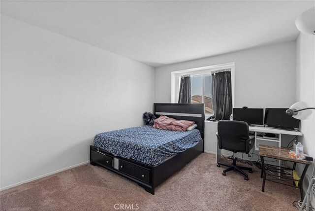 carpeted bedroom with baseboards