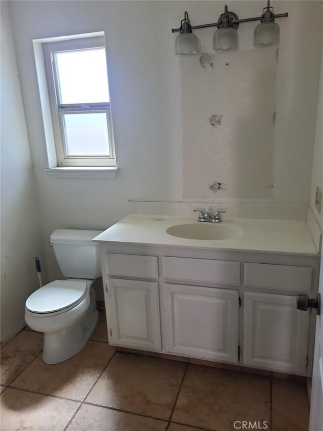 bathroom with toilet and vanity