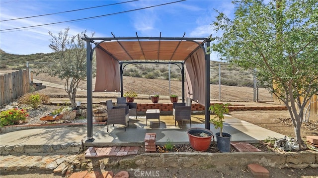 view of patio with a pergola and fence