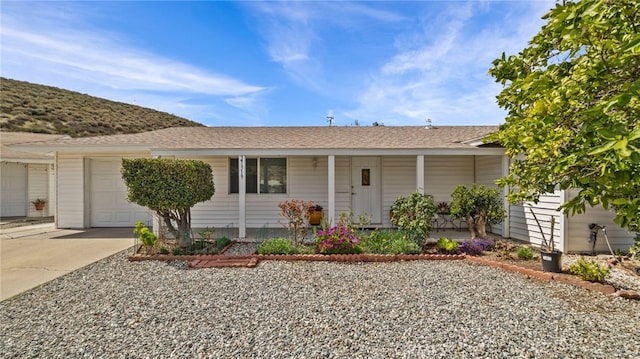 single story home with a garage, covered porch, and driveway