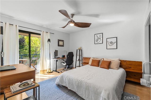 bedroom featuring wood finished floors, baseboards, and ceiling fan