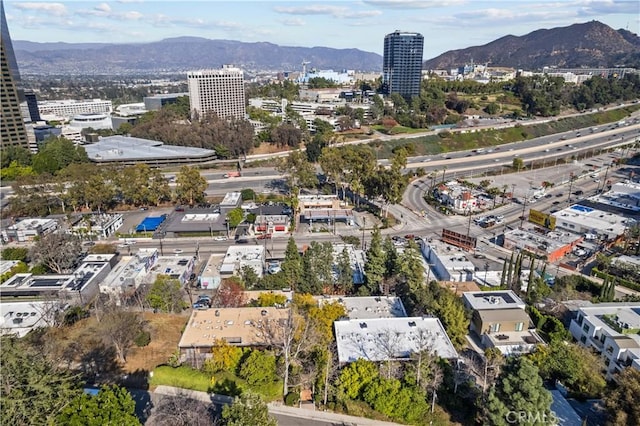 aerial view featuring a view of city and a mountain view