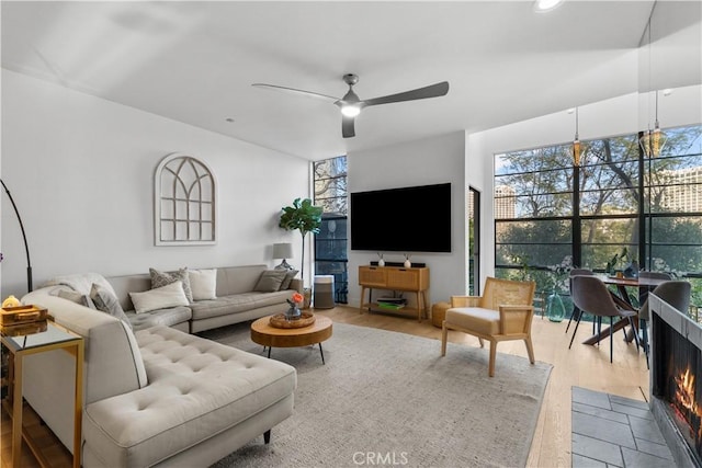 living room with a ceiling fan and wood finished floors