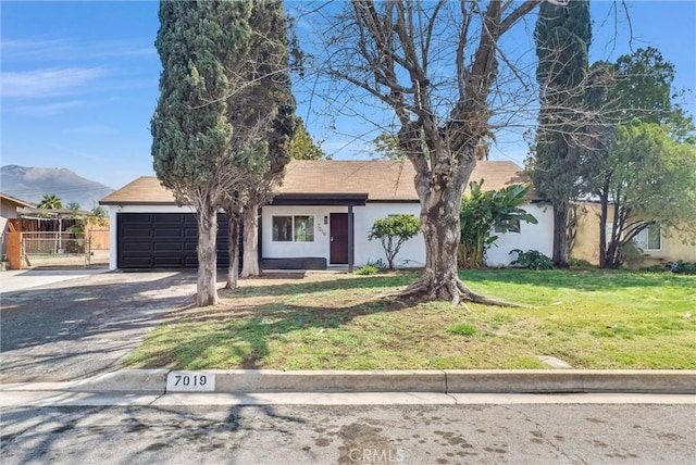 ranch-style home featuring stucco siding, fence, concrete driveway, a front yard, and a garage