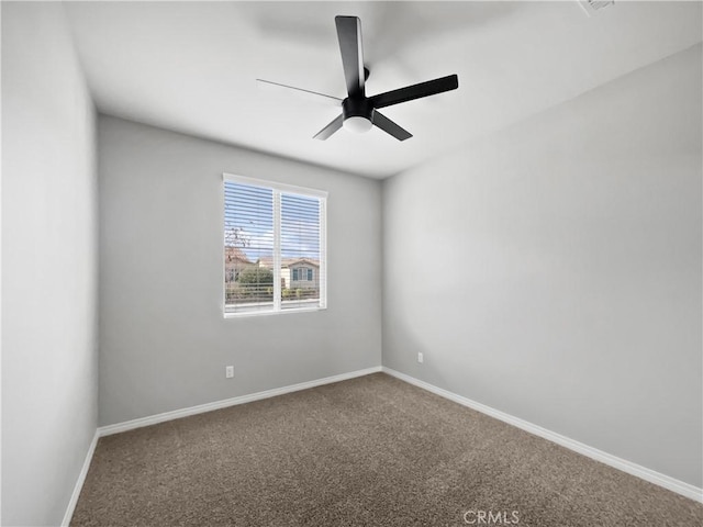 spare room with baseboards, carpet, and ceiling fan