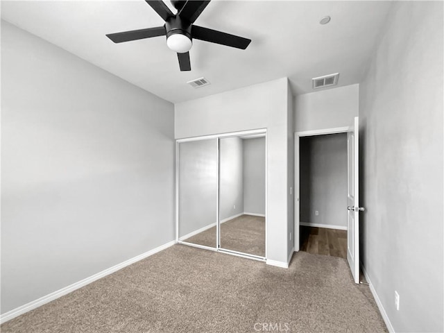 unfurnished bedroom with visible vents, baseboards, carpet floors, and a closet