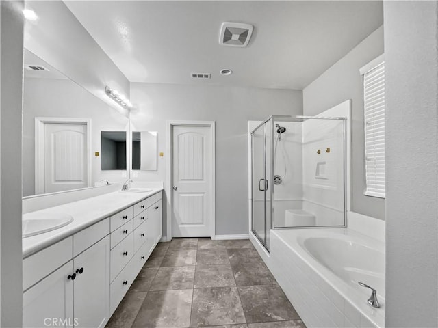 full bathroom featuring visible vents, a shower stall, double vanity, a bath, and a sink