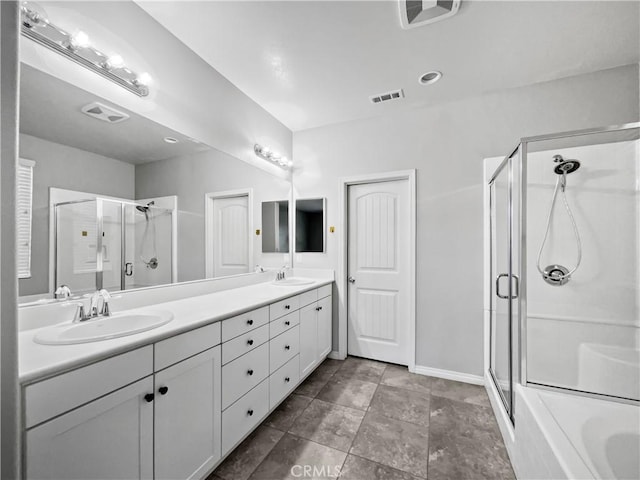 full bathroom featuring double vanity, visible vents, a stall shower, and a sink