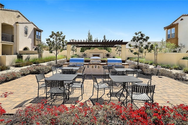 view of patio / terrace with outdoor dining space, area for grilling, fence, and a pergola