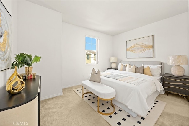 bedroom featuring baseboards and light carpet