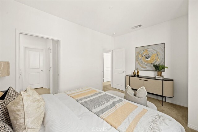 carpeted bedroom featuring visible vents and baseboards