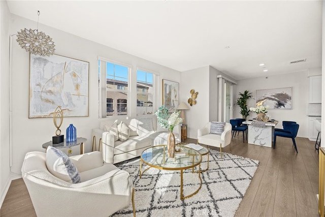 living room with visible vents and hardwood / wood-style floors