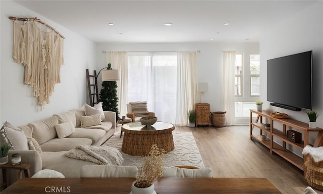 living area featuring recessed lighting and light wood finished floors