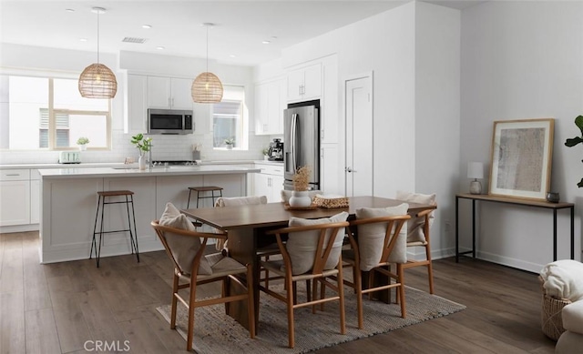 dining area featuring recessed lighting, visible vents, plenty of natural light, and dark wood-style floors