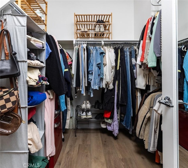 walk in closet with wood finished floors