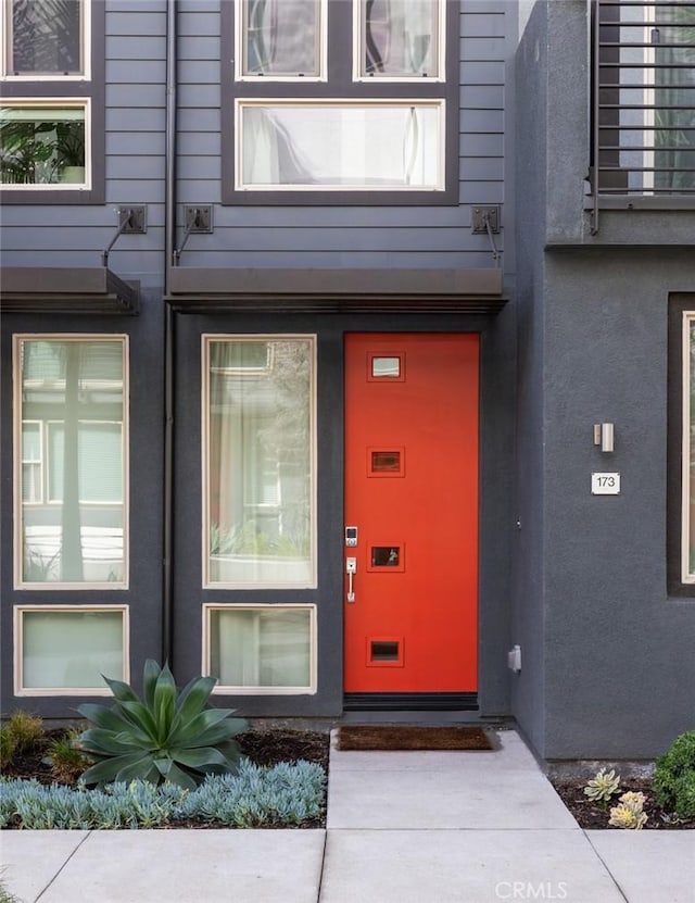 property entrance with stucco siding