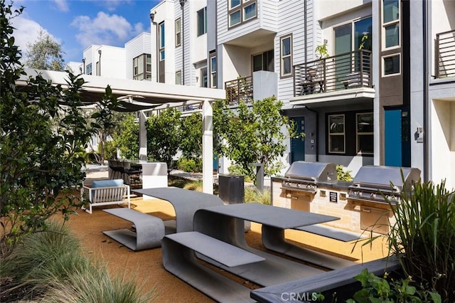 view of patio / terrace featuring outdoor dining space, area for grilling, and a residential view