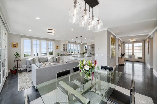 dining area featuring a healthy amount of sunlight, french doors, and ornamental molding