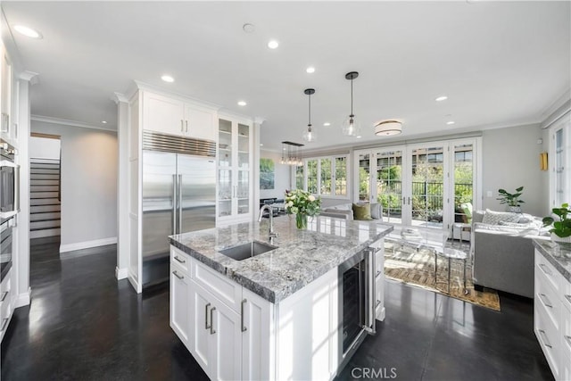 kitchen featuring beverage cooler, a sink, ornamental molding, stainless steel appliances, and french doors