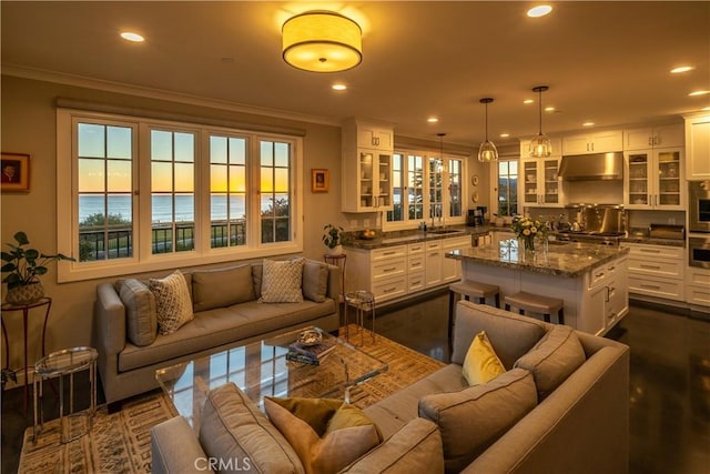 bar featuring under cabinet range hood, recessed lighting, crown molding, and a sink