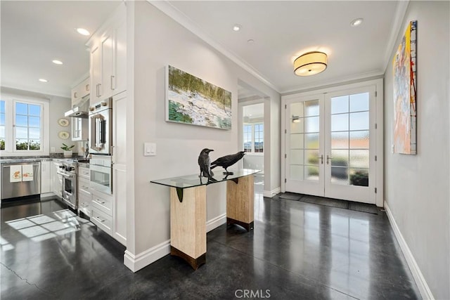 interior space with baseboards, concrete flooring, and ornamental molding