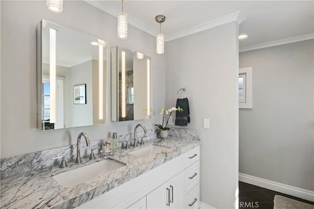 bathroom featuring tile patterned floors, ornamental molding, baseboards, and a sink