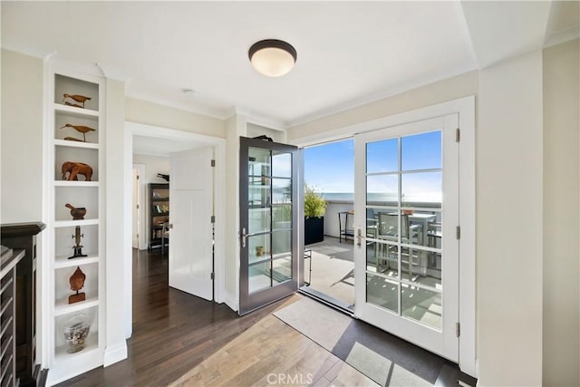 doorway featuring ornamental molding and wood finished floors