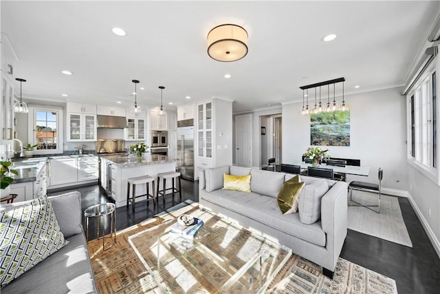 living room with recessed lighting, plenty of natural light, and crown molding