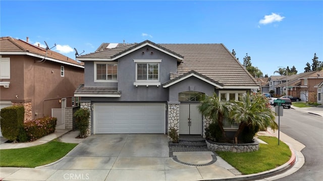 traditional home with stone siding, driveway, and a tile roof