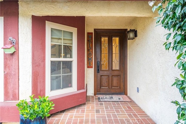 entrance to property with stucco siding