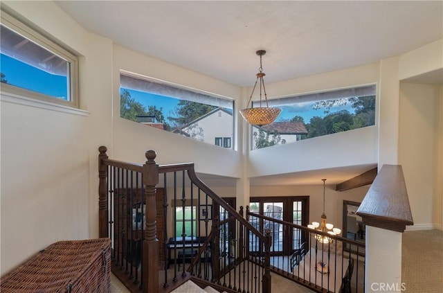 stairs with a high ceiling and carpet