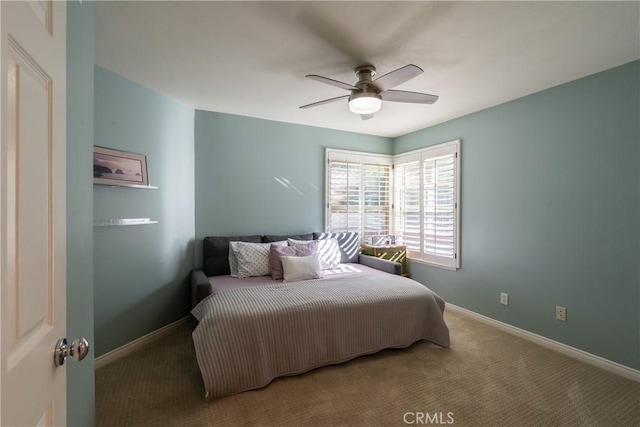 bedroom featuring baseboards, ceiling fan, and carpet flooring